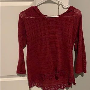 Red crocheted sweater with hood.